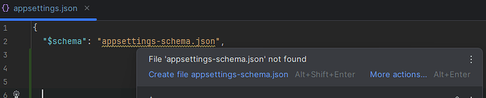 A screenshot of a code editor shows an error message that the file "appsettings-schema.json" was not found, prompting the user to create the file. (Captioned by AI)